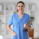 Nurse smiling and holding clipboard